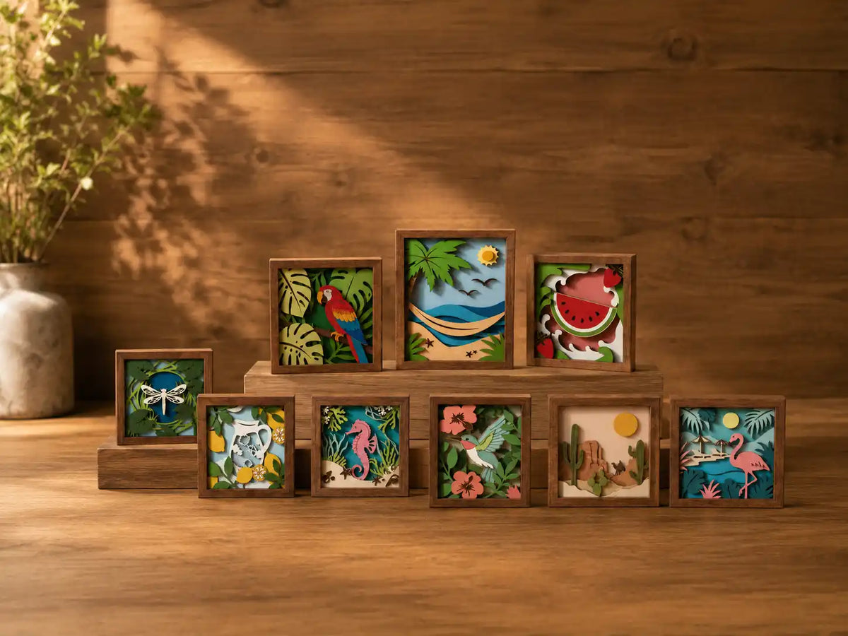 Colorful laser-cut project designs displayed in wooden frames